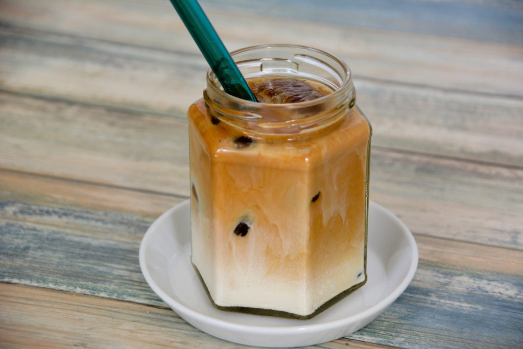 Honey Vanilla Oat Milk Iced Latte with glass straw