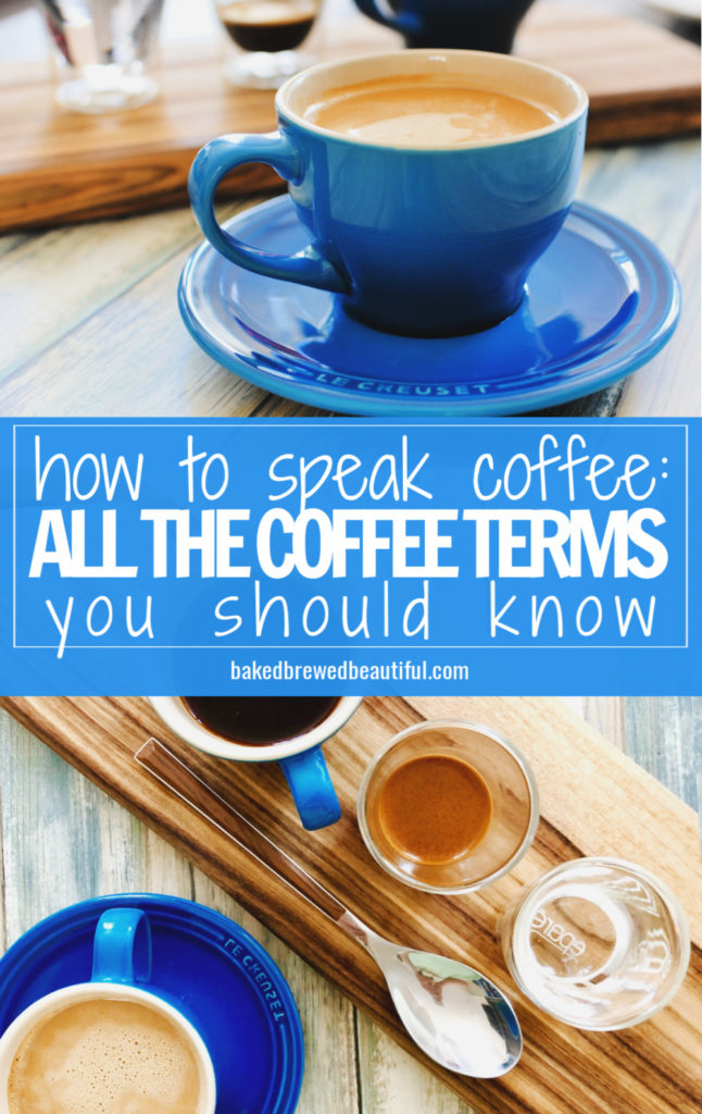 coffee mugs and saucers on a wooden plank with espresso, seltzer, and a hot latte