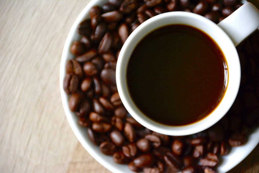 coffee cup with coffee beans on a saucer