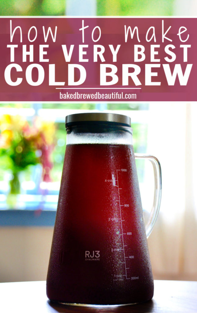 ovalware cold brew maker on a wooden table with fall flowers in the background with blue windows