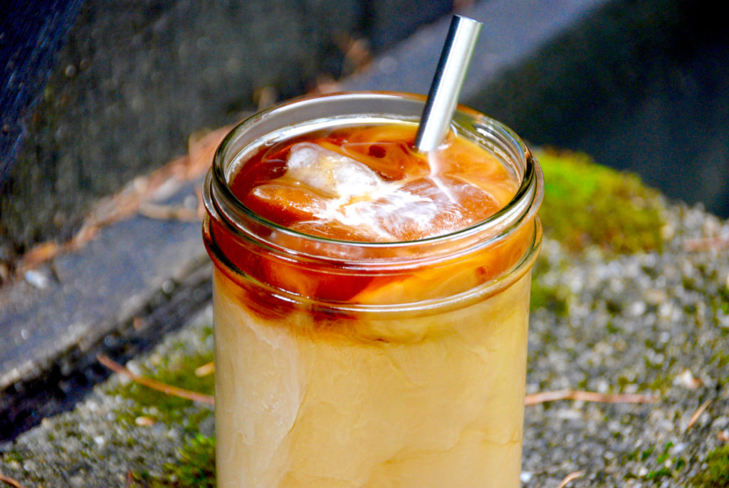 gingerbread iced latte on pavement with moss