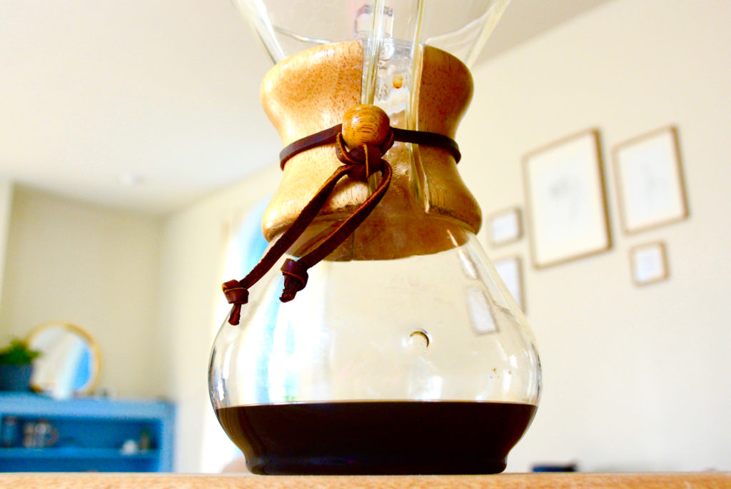 Chemex filled with coffee on a table top