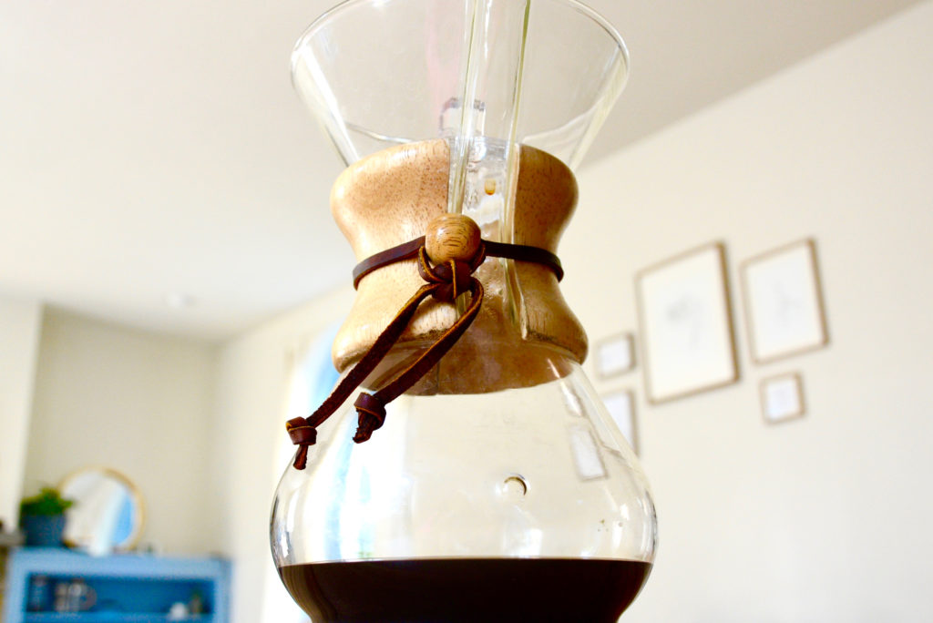 Chemex filled with coffee on a table top 