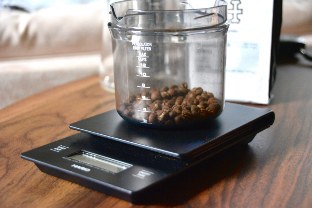 Hario scale with whole coffee beans being measured