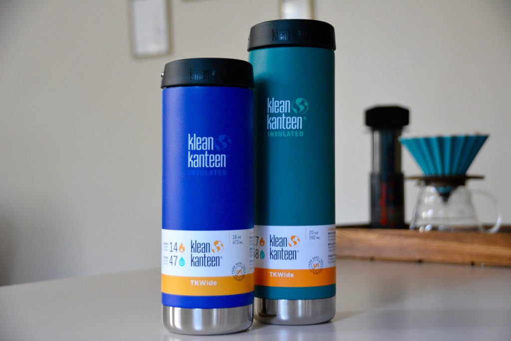 one blue and one teal klean kanteen insulated travel mugs on a counter