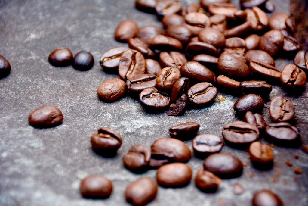 whole coffee beans on pavement