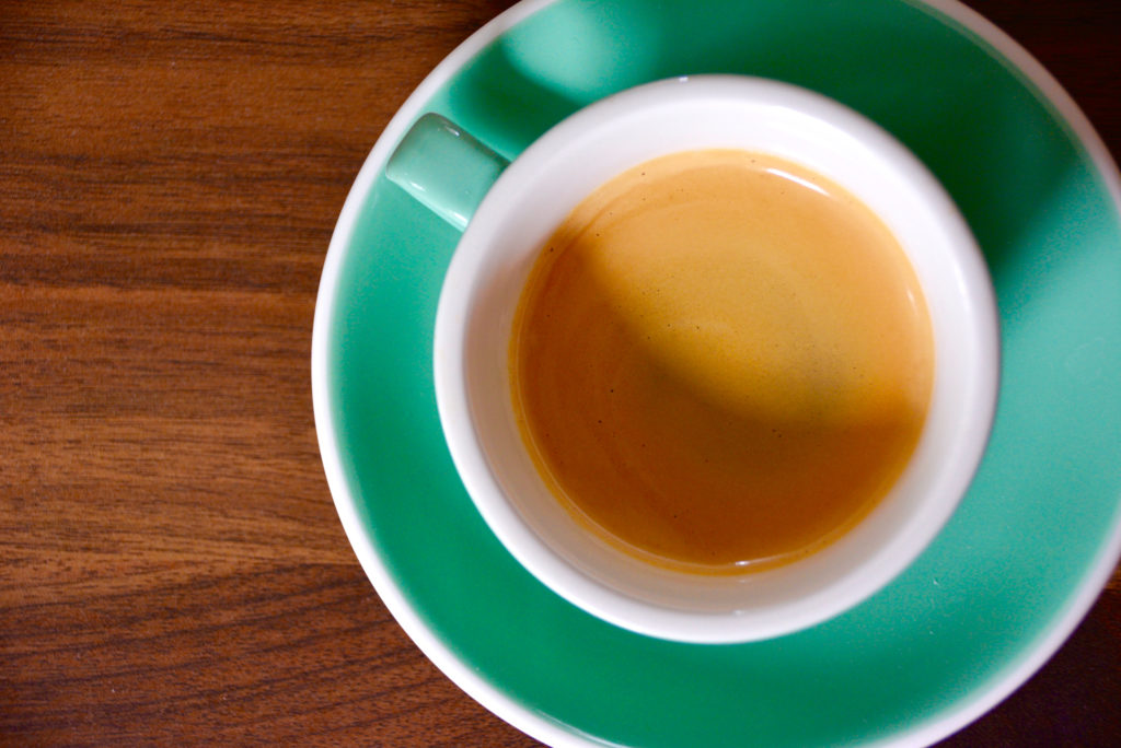 espresso in a green cup with crema