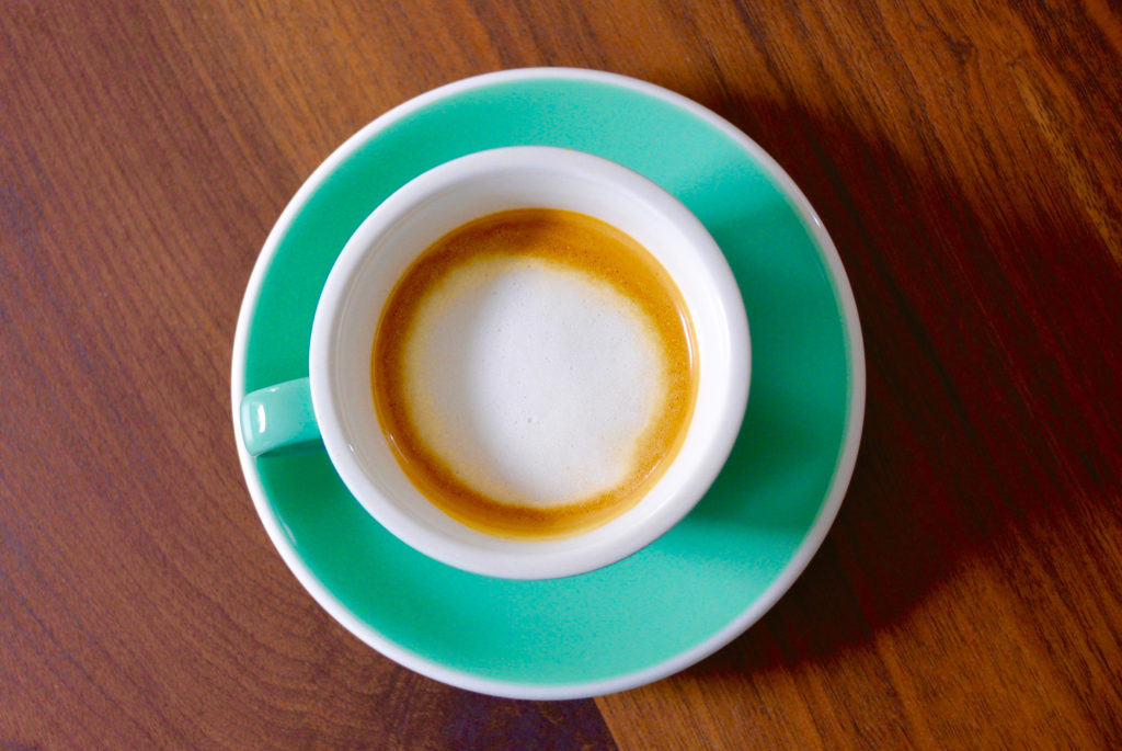 espresso and milk foam on wood table