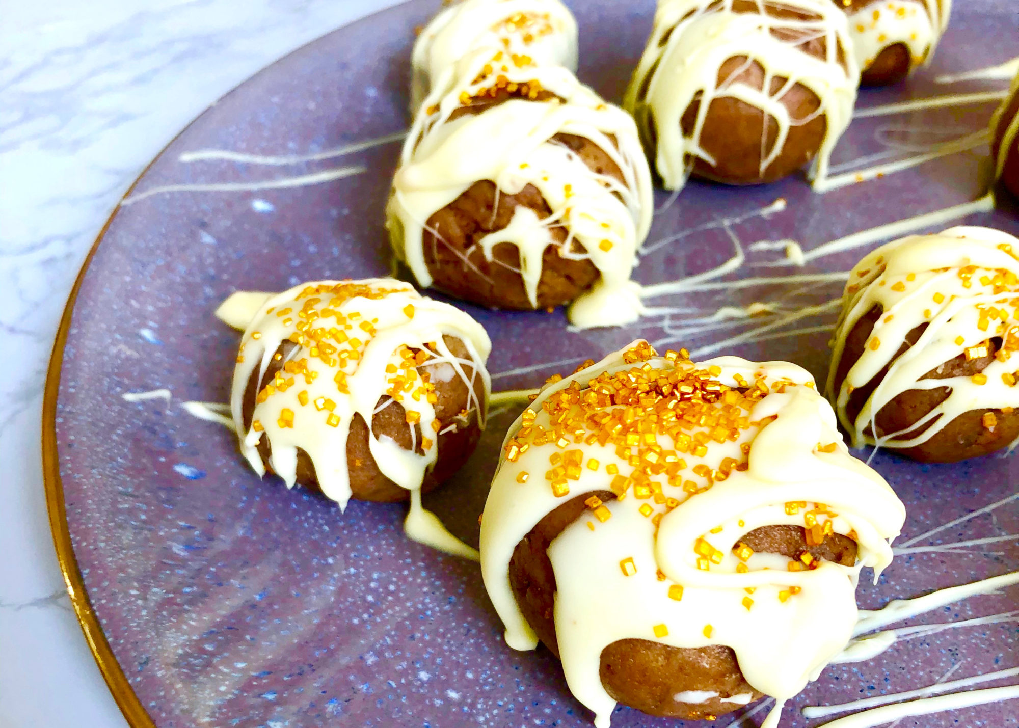 chocolate cake truffles with white chocolate drizzle