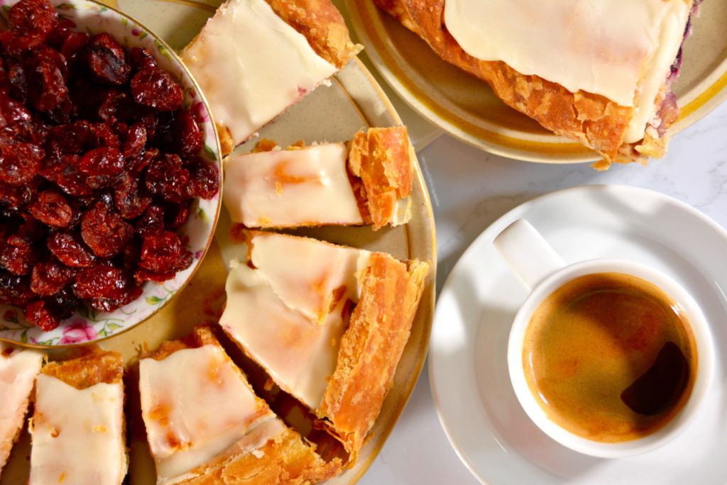 kringle or danish on a plate with coffee