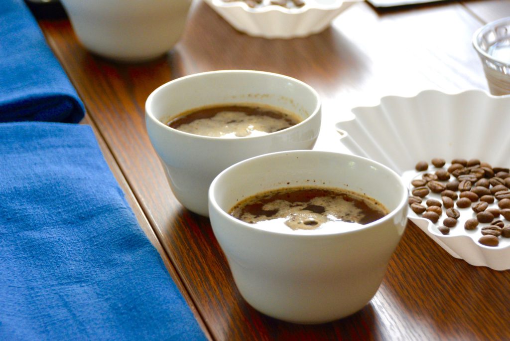 breaking crust at a cupping coffee session