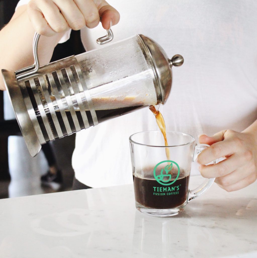 Tieman's coffee being poured into glass cup