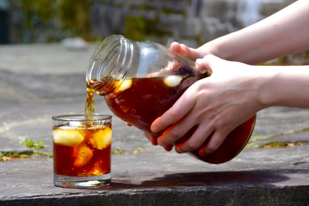 pouring cold brew into a glass