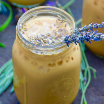 iced honey lavender latte in a mason jar outside