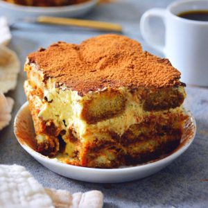 tiramisu on a plate with coffee 