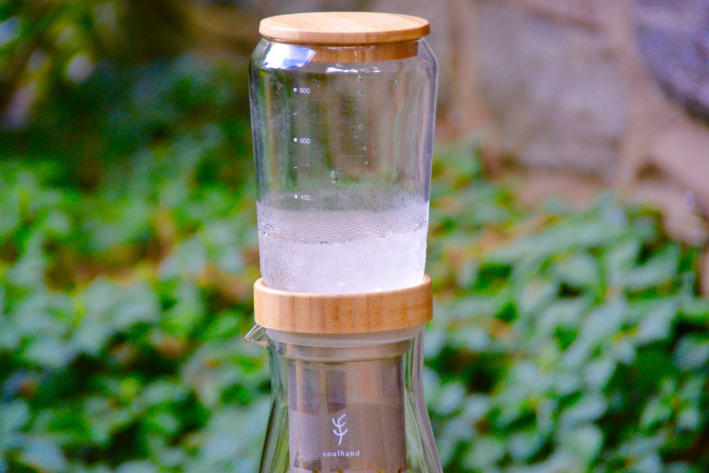 upper chamber of an ice drip coffee tower with ice water