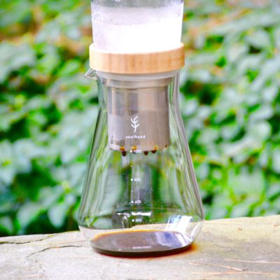 soulhand cold brew coffee maker on pavement with greenery in background