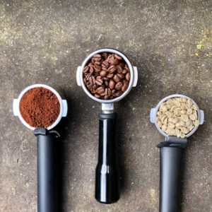 group heads with coffee beans and coffee grounds 