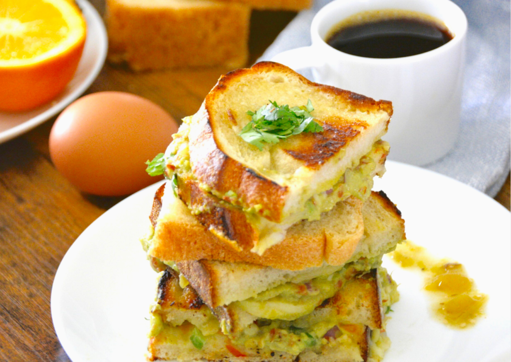 grilled cheese on a while plate with coffee