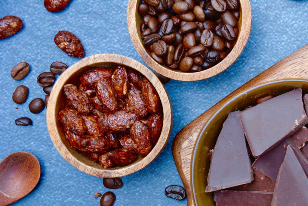 wood bowls of coffee beans and chocolate almonds 