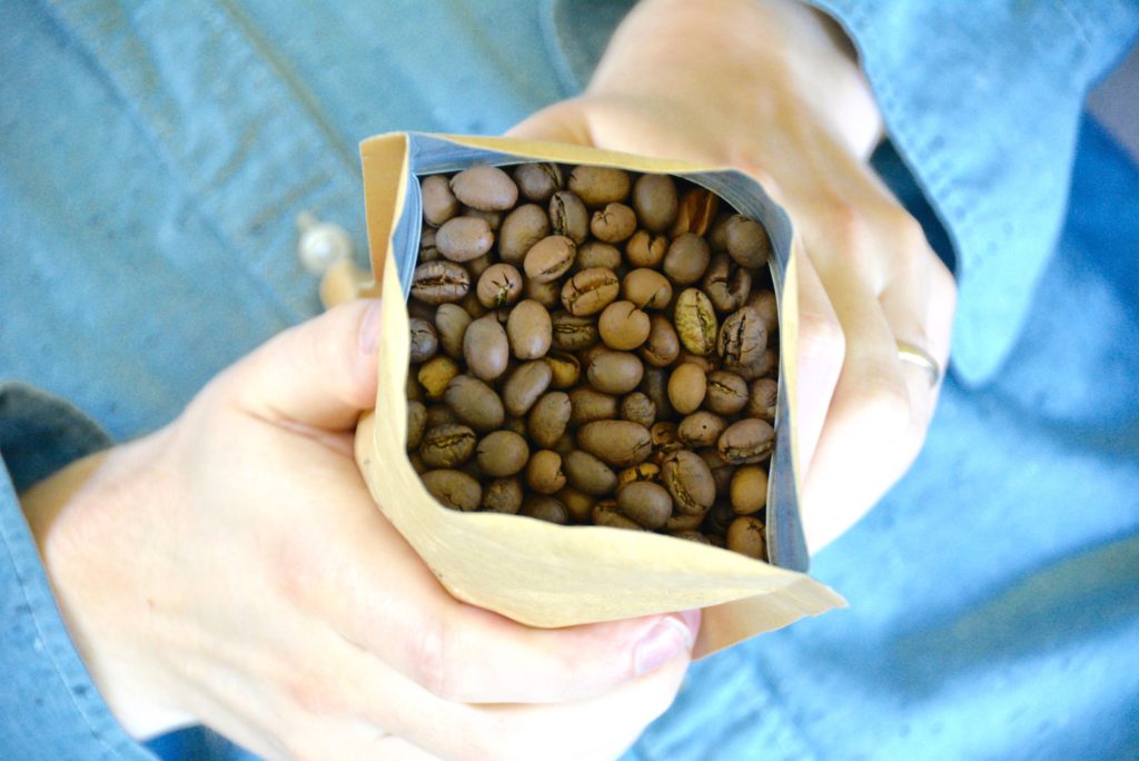 man holding a bag of coffee beans 