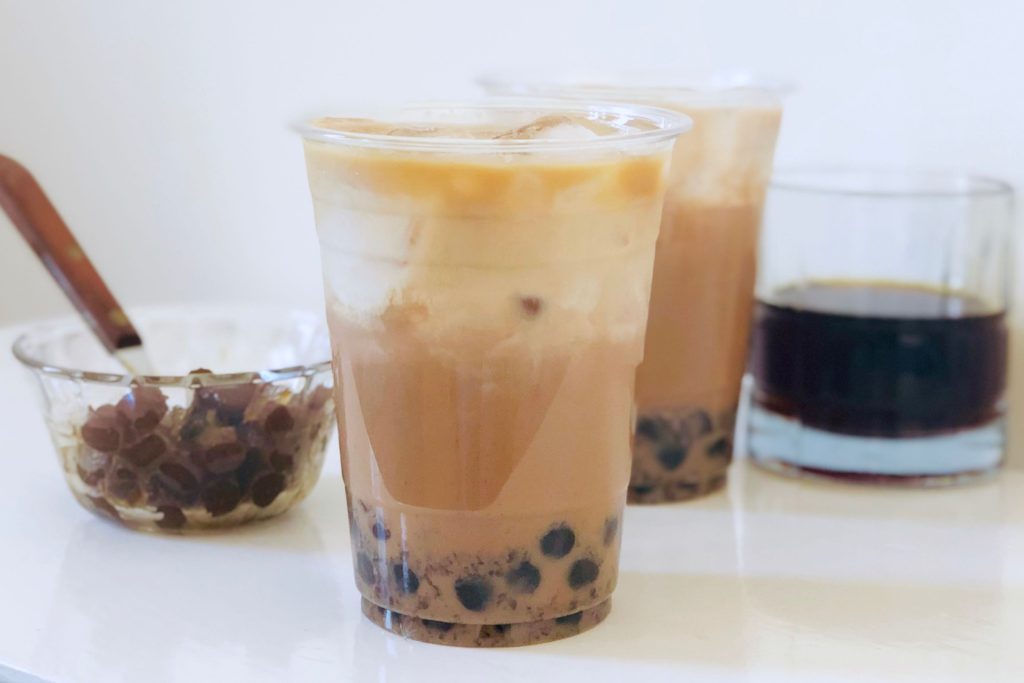 coffee and boba coffee in plastic cups with white background