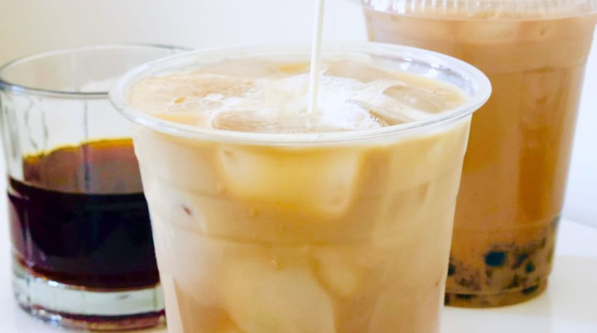 milk being poured into boba coffee plastic cup