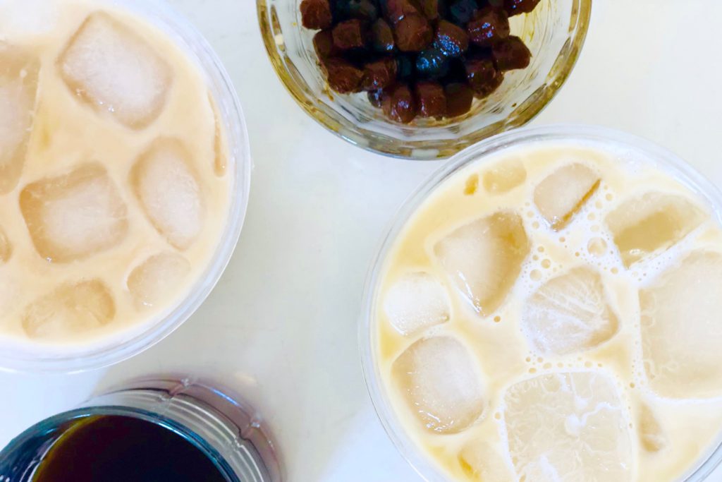 boba coffee flat lay on white background with tapioca balls and boba coffee top view